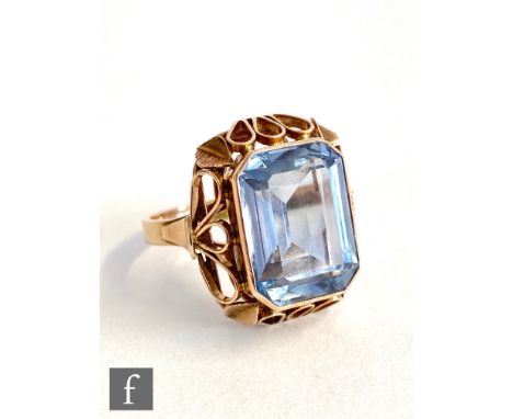 A 14ct single stone blue spinel ring, emerald cut collar set stone, length approximately 20mm, to a pierced head, weight 8.7g