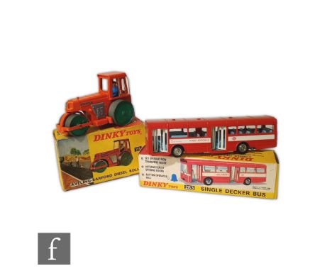 Two Dinky Toys diecast models, a 279 Aveling-Barford Diesel Road Roller in orange with green metal wheels, grey plastic engin