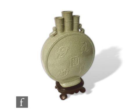 A Chinese Guanyao style moonflask, bianhu, the rounded relief moulded body with auspicious characters, rising to a three aper