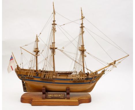 A 1/60th scale model of HMS Bounty:, standing and running rigged over planked deck the planked hull with blue gunwales raised