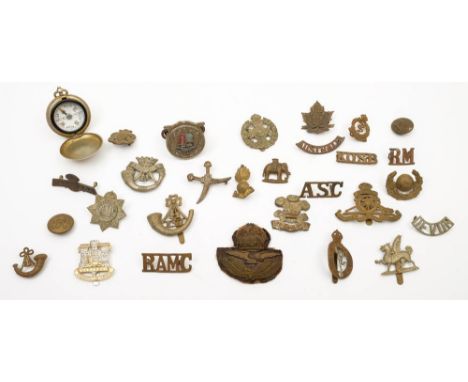 A small collection of various cap and shoulder badges together with a pocket compass:, including Devonshire Regiment and Corn