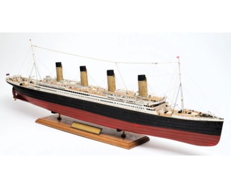 A scale model of HMS Titanic:, fully rigged with radio masts over funnels and detailed decks with davits and lifeboats, the h