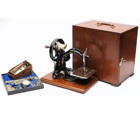 An early 20th century black lacquer and gilt 'Silent Sewing Machine' by Wilcox & Gibbs, London:, together with a cased access