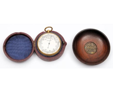 A 19th century gilt compensated pocket barometer, unsigned and a small dish made from teak from HMS Terrible:, (2).