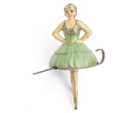 A mid-20th century tinplate ballerina gyroscope:, the polychrome lithograph printed figure enclosing a weighted gyroscope ope