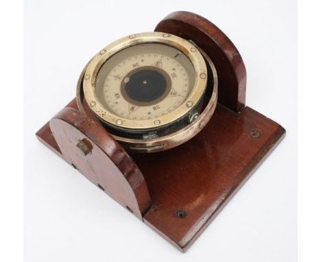 A 4 inch liquid filled compass:, no 8256K, in brass gimbaled mount on later wooden plinth.