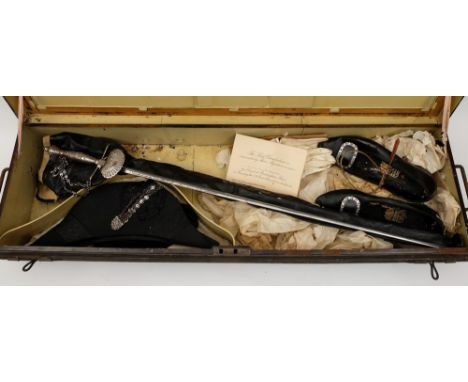 An early 20th century court sword together with a bicorn hat, a pair of court shoes and white kid gloves in a tin trunk:, als