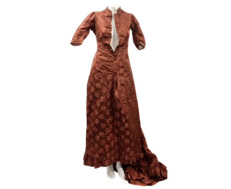 A late 19th/early 20th century floral embroidered silk dress:, with short mandarin collar, button front and pleated hem, the 