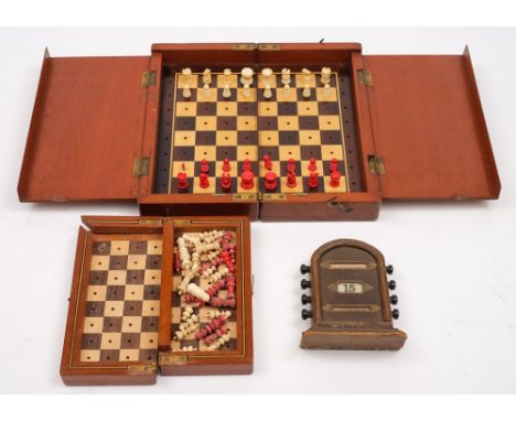 An early 20th century mahogany folding chess set with turned ivory pieces and one other smaller:, (both incomplete) and a lea