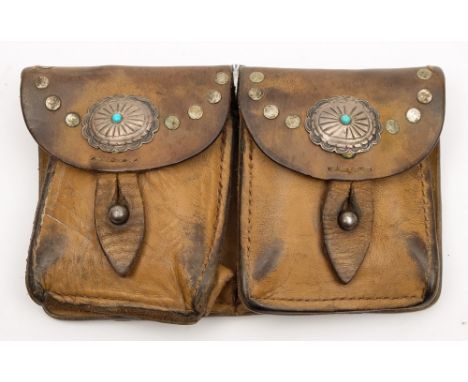 A Western style leather double ammunition pouch:, with pressed oval applique and studded decoration, double belt loop to reve