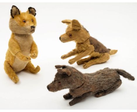 A blonde plush fox by Steiff, together with two similar dogs:, the former with glass eyes, stitched nose and mouth  and butto