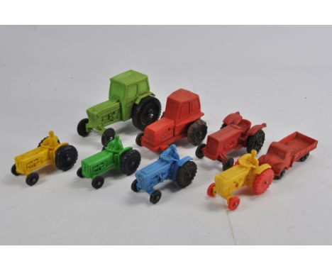 An interesting group of Tomte Type Tractor Models in various colours. Rubber made. (8)