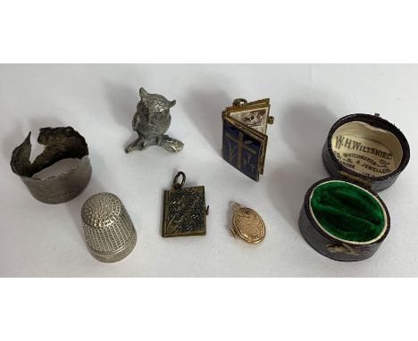 A Georgian silver caddy spoon together with various other silver spoons, a small gold locket and other collectable items