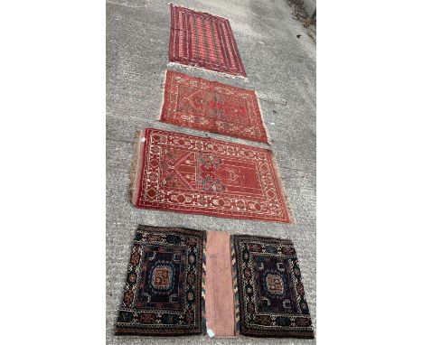 A 20th century prayer rug, with decorative central panel, within borders on a burnt orange ground, 117.5cm x 80.5cm; another 