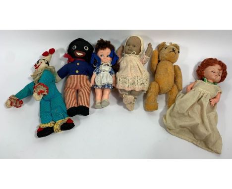 A collection of vintage dolls and soft toys