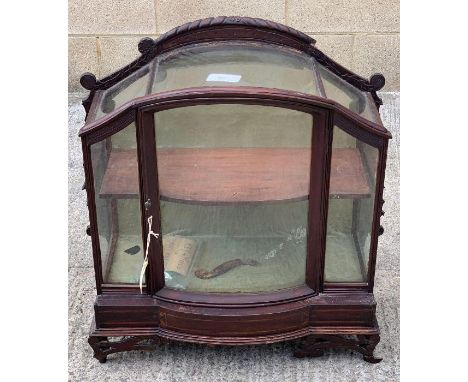 An ornate 19th century stained hardwood table top display cabinet, the sides and front glazed, with single door opening to a 