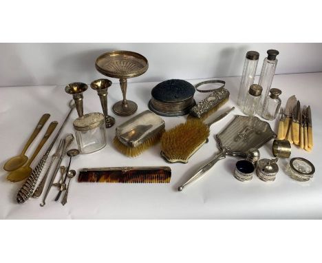 An oval silver trinket box, with lift off padded pin cushion cover; a silver backed hand mirror, hair brush and comb dressing