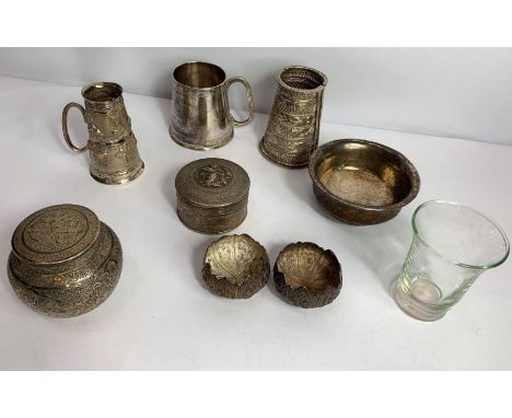 A collection of eastern metalware, comprising: a mug; a double drinks measure; a pair of salts; a small tea caddy; a circular