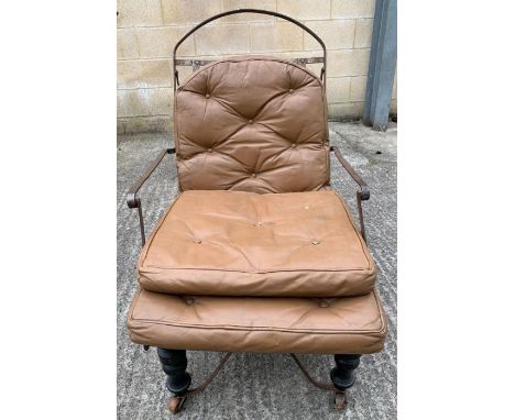 An early 20th century iron framed campaign bed, the mid brown leather with button detail, two front ebonised legs and four wo