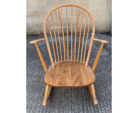 A mid-20th century Ercol style low rocking chair, with hoop back and spindle supports, floor to seat height 31cm