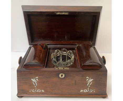 A 19th/20th century rosewood veneer and mother of pearl inlay  tea caddy, of sarcophagus form, the hinged lid opening to two 