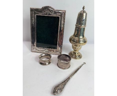 A late Victorian silver sugar caster, makers mark obliterated, London 1894, 18.5 cm high, two silver napkin rings; 185 g (5.9