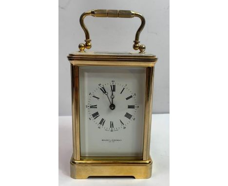 A late 20th century French eight day carriage clock, retailed by Bracher &amp; Sydenham, striking on a bell, within a brass c