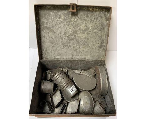 A collection of vintage tin cooking moulds and cutters, in various shapes and sizes including hearts and flowers; all contain