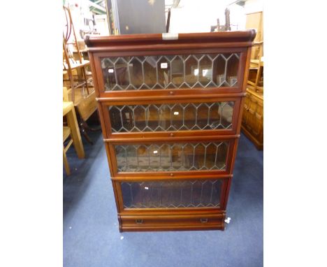 A GLOBE WERNICKE LEAD GLAZED FOUR SECTION BOOKCASE, with lower drawer (presentation plaque attached to the top)