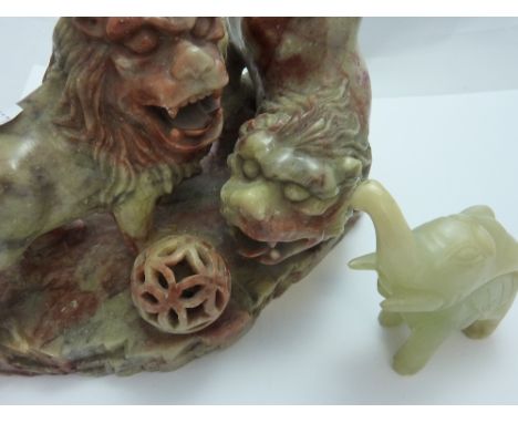 TWO FIGURES, to include a soapstone carving of lions and a carved jade elephant