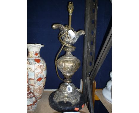 A CAST TABLE LAMP, on plinth