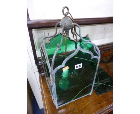 AN EARLY 20TH CENTURY HANGING LANTERN, with green glass panels (one panel broken)