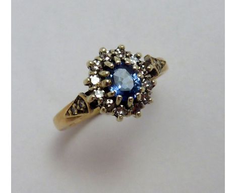 A SAPPHIRE AND DIAMOND RING, the central cornflower blue sapphire within a surround of single cut diamonds to the diamond tap