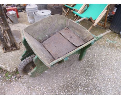 A VINTAGE WOODEN FRAMED WHEELBARROW