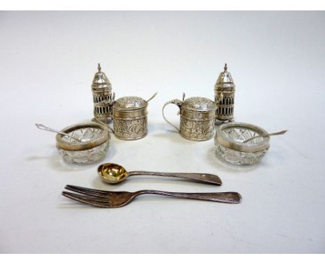 A GROUP OF EDWARDIAN SILVER CONDIMENTS, to include a pair of repousse mustard pots, a pair of openwork pepper pots, a pair of