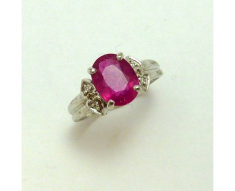 A 9CT GOLD RUBY RING, the oval ruby with single cut diamond details to the sides to the tapered band, hallmarks for Birmingha