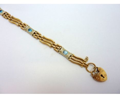 A GATE BRACELET, with curved link detail and panels with topaz to the heart shape padlock, hallmarks for Birmingham