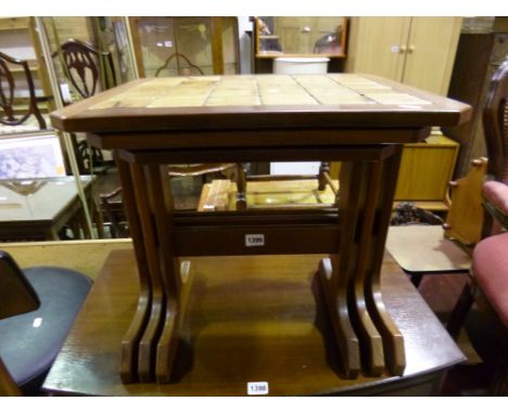 A TILE TOPPED NEST OF THREE TABLES