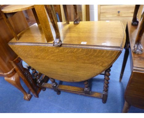 AN OAK BARLEY TWIST GATE LEG TABLE