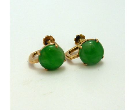 A PAIR OF JADE EARRINGS, the circular jade cabachons to the rose gold screw thread backs