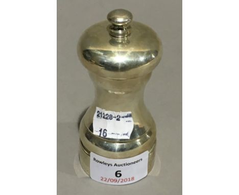 A silver pepper grinder