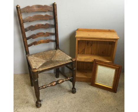 A ladder back chair, a maple framed mirror and a small modern bookcase