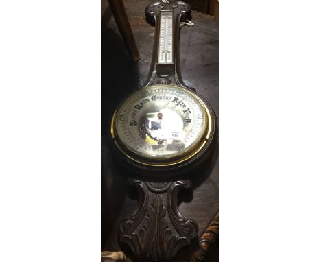 A Victorian carved oak barometer