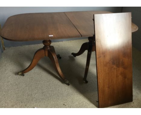 A mahogany reproduction twin pillar dining table