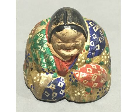 A painted wooden netsuke