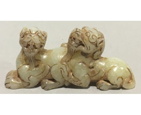 A Chinese jade carving formed as two dogs-of-fo