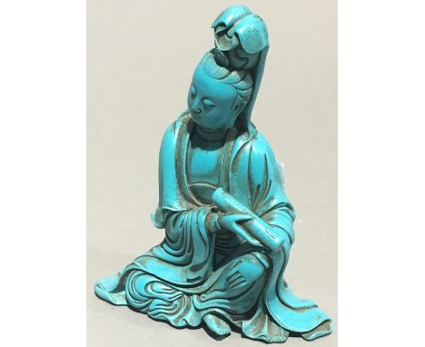 A Chinese turquoise figure of Guanyin, modelled seated holding a scroll