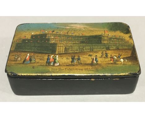 A Victorian papier mache snuff box decorated with The Crystal Palace