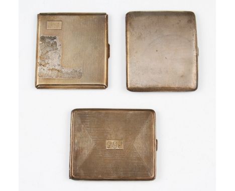 A lot to include three silver cigarette cases, the first having overall machined wave design with blank rectangular cartouche