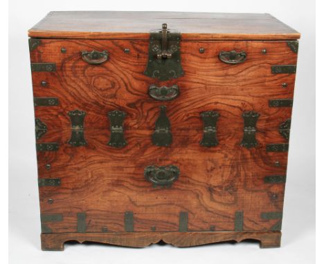 A 19th Century elm campaign trunk having patterned brass mounts, handles, hinges and central latch, hinges having Oriental ch